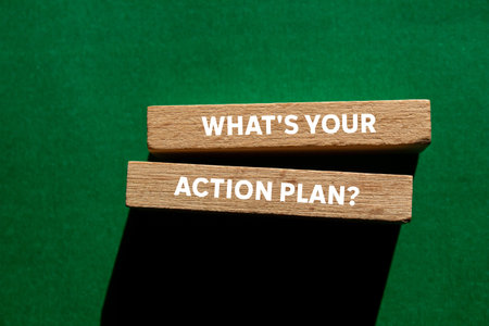 What's your action plan message written on wooden blocks on green background. Conceptual what's your action plan symbol. Copy space.の写真素材