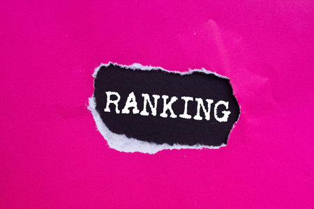 Ranking message written on ripped torn pink paper on black background. Conceptual ranking symbol. Copy space.の写真素材