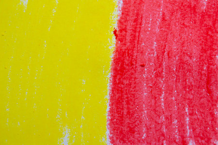 Vibrant yellow red oil pastel paint texture with soft strokes, slightly rough surface, artistic backgroundの写真素材