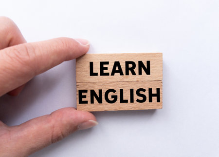 Learn english message written on wooden blocks on white background. Conceptual learn english symbol. Copy space.の写真素材