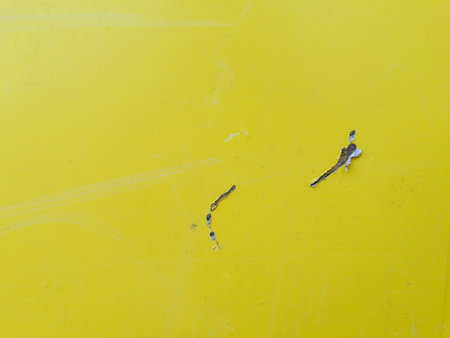 Weathered yellow paper poster texture backgroundの写真素材
