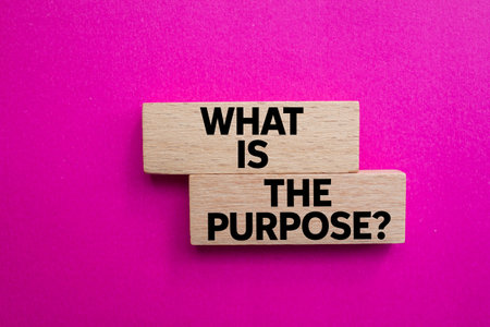 What is the purpose message written on wooden blocks on pink background. Conceptual what is the purpose symbol. Copy space.の写真素材