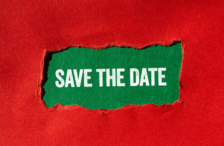 Save the date message written on torn red paper on green background. Conceptual save the date symbol. Copy space.の写真素材