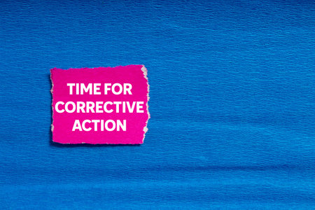 Time for corrective action message written on ripped torn pink paper on blue background. Conceptual time for corrective action symbol. Copy space.の写真素材