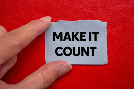 Make it count message written on ripped torn gray paper piece on red background. Conceptual make it count symbol. Copy space.の写真素材