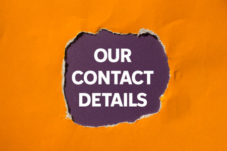 Our contact details message written on ripped torn orange paper on purple background. Conceptual our contact details symbol. Copy space.の写真素材