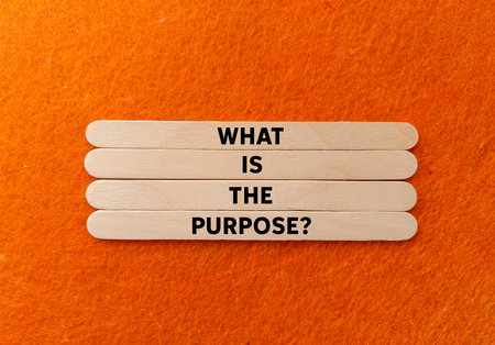 What is the purpose message written on wooden sticks on orange background. Conceptual what is the purpose symbol. Copy space.の写真素材