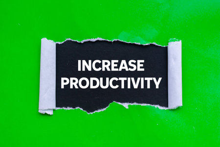 Increase productivity message written on ripped torn green paper on black background. Conceptual...