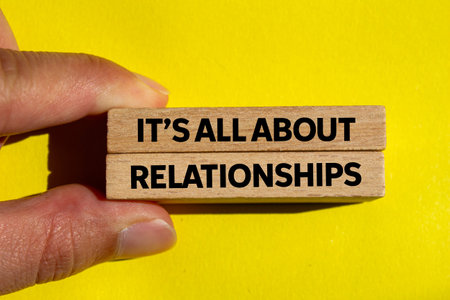 It's all about relationships message written on wooden blocks on yellow background. Conceptual it's all about relationships symbol. Copy space.の写真素材