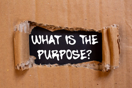 What is the purpose message written on torn torn cardboard paper on black background. Conceptual what is the purpose symbol. Copy space.の写真素材