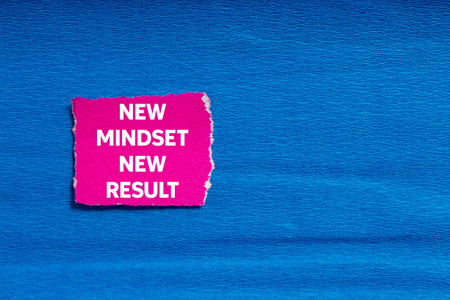 New mindset new result message written on ripped torn pink paper on blue background. Conceptual new mindset new result symbol. Copy space.の写真素材