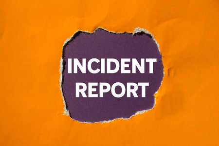 Incident report message written on ripped torn orange paper on purple background. Conceptual incident report symbol. Copy space.の写真素材