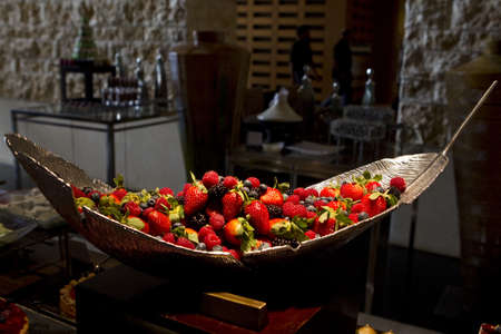 Pile of fresh mixed berries - strawberries, blackberries and raspberries in a bowl.の写真素材
