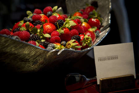 Pile of fresh mixed berries - strawberries, blackberries and raspberries in a bowl.の写真素材