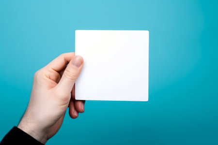 empty white blank mockup in hand on blue background generative ai.の素材