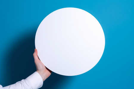 circle empty white mockup in hand on blue background generative ai.の素材