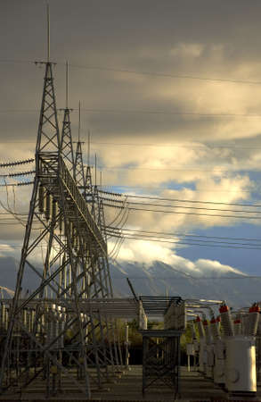 Transofmer station set against mountains and clouds