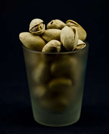 Pistachio nuts in a shot glassの写真素材