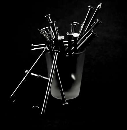 A shot glass full of nails, insideの写真素材