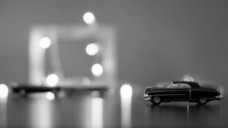 Classic toy car on blurred background with bokeh light effectの写真素材