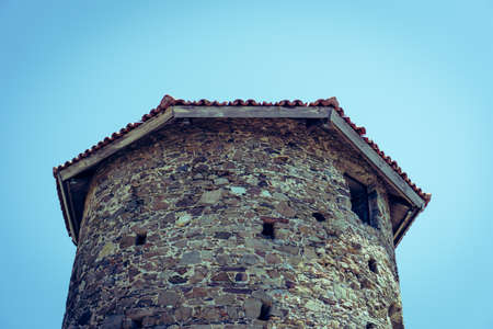 Stone tower with sky in the background. Roof and top part of a stone tower in Bodrum, Turkey.の写真素材