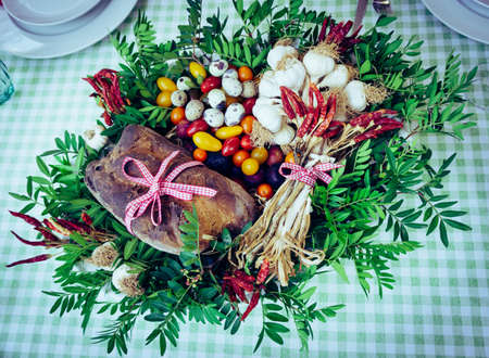 Organic vegetables bread and quail eggs in the basket. On the table. Decorative.