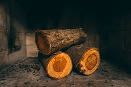 Pile of unburned wood logs in the fireplace. Ready to be set in fire.の写真素材