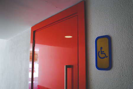 An entrance to the toilet for the disabled. Badge.
