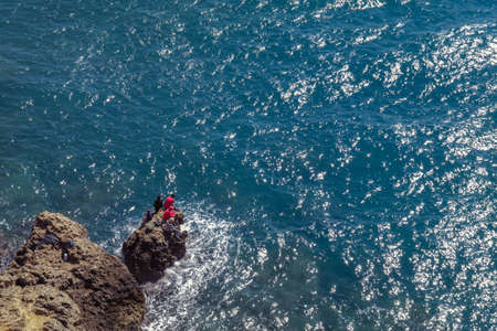 Antalya, Turkey - 15th April 2017: Men fishing on the rocks. Seashore. Group of people on rocks by...