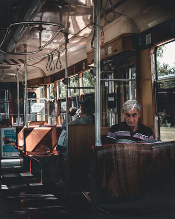 Antalya, Turkey - 6th October 2019: Portrait of a man sitting in nostalgic tramway. Nostalgic tramway in Antalya gives tourists and locals small ride through city.の写真素材