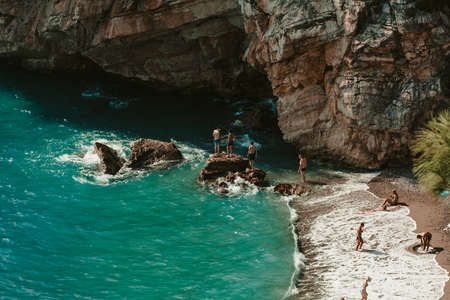 Antalya, Turkey - 19th September 2020: People at the beach in the small coy. People bathing in the mediterranean sea in Antalya.のeditorial素材