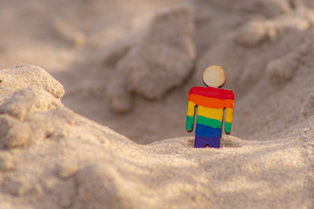 Rainbow gay man standing in the sand on the beach. LGBT conceptの写真素材