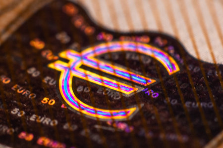 Macro detail of a euro symbol on a paper background with shallow depth of fieldの写真素材