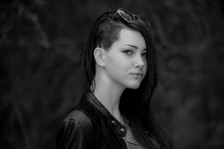 Portrait of a beautiful girl in the forest. Black and white photo.