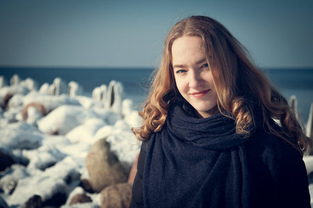 Portrait of a beautiful young woman on the background of the seaの写真素材
