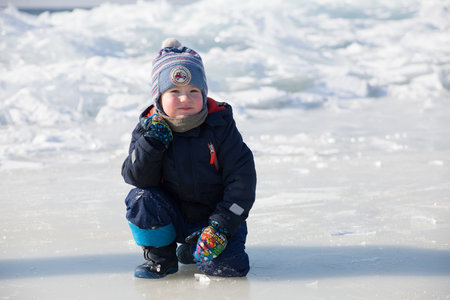 Little boy on the ice of Lake Baikal in winter.
