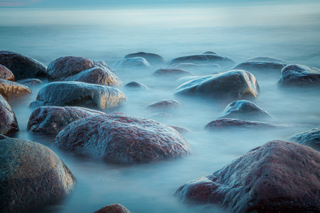 Seascape with rocks in the sea at sunrise. Long exposureの写真素材