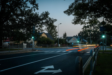 Road on the street at night with light trails from cars passing byの写真素材