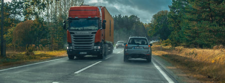 Trucks on the highway in autumn, panoramic viewの写真素材