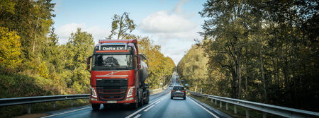 Truck driving on the road in autumn, panoramic viewの写真素材