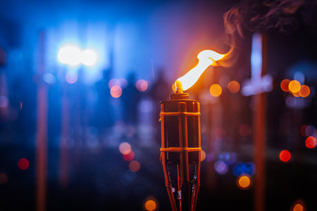 Burning torch on the background of the city at night. Close-upの写真素材