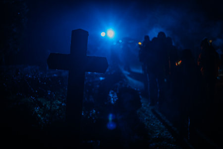 Silhouettes of zombies at cemetery at night. Horror Halloween concept. Selective focusの写真素材