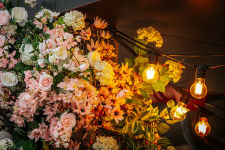 Flower arrangement with light bulbs on the wall in vintage style.の写真素材