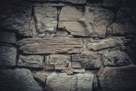 Background of stone wall texture. Vintage tone filter effect color style.の写真素材
