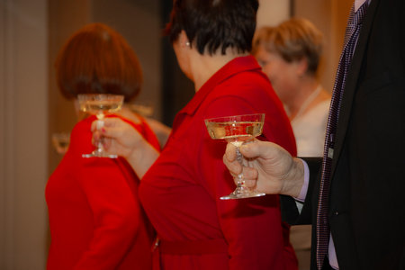 Wedding couple with champagne glasses on the background of guests.の写真素材