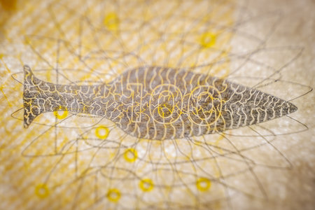 Close-up of a fishing net on a background of yellow threadsの写真素材