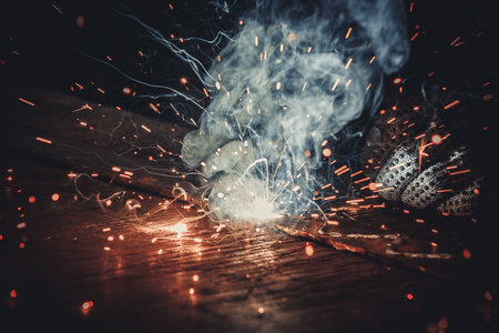 Welding work with sparks and smoke, close-up.の写真素材