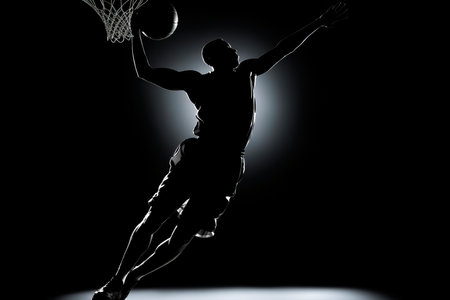 Basketball Player Slam Dunk Silhouette. Capture the dynamic movement of a basketball soaring towards the hoop, against a bright backdropの素材
