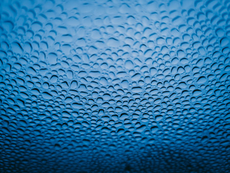Water drops on glass, blue background. Shallow DOF.の写真素材