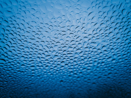Water drops on the glass, blue background, close-up.の写真素材
